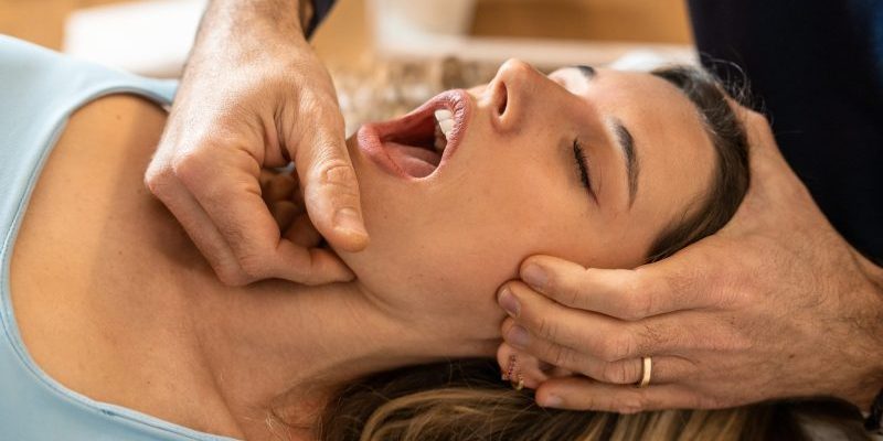 An,Osteopath,Performs,A,Jaw,Adjustment,On,A,Female,Patient, TMJ Therapy alexandria