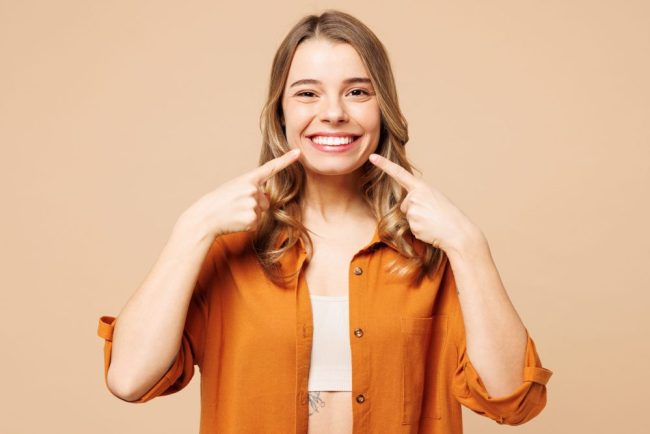 Young,Smiling,Happy,Caucasian,Woman,She,Wear,Orange,Shirt,Casual dental cleanings near me